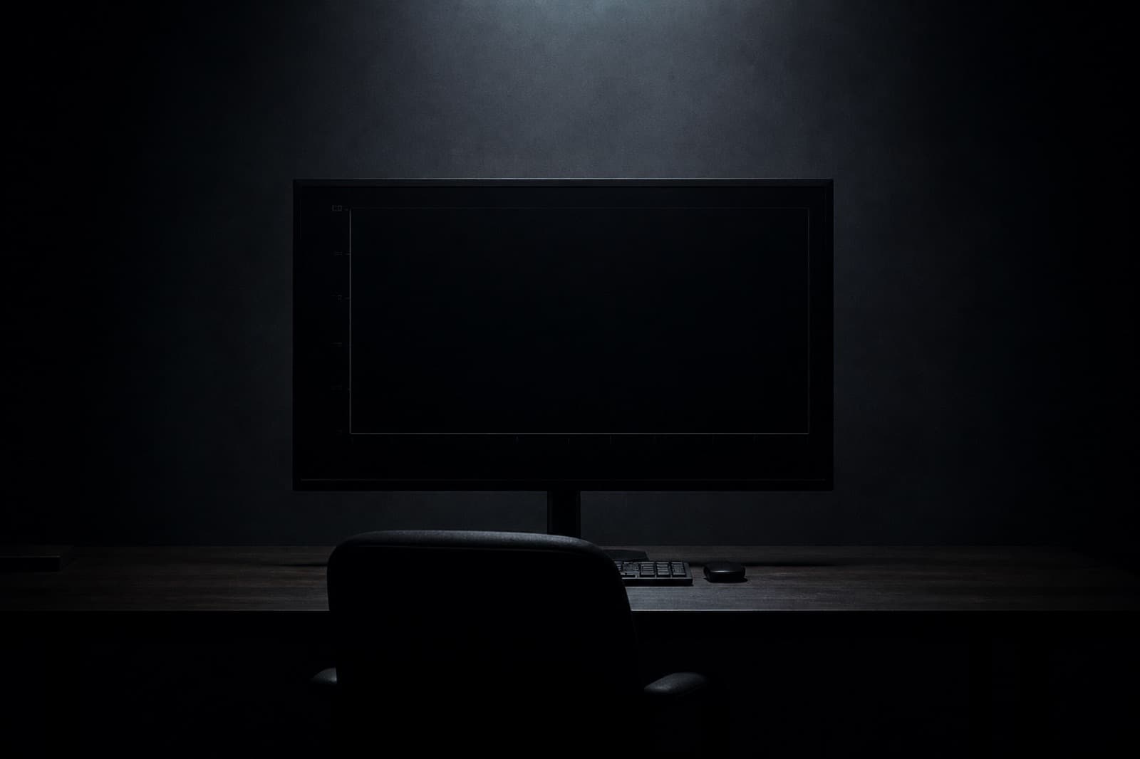 A dark studio with a large monitor showing an almost empty chart